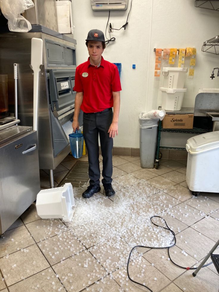 a man in a red shirt is cleaning the floor