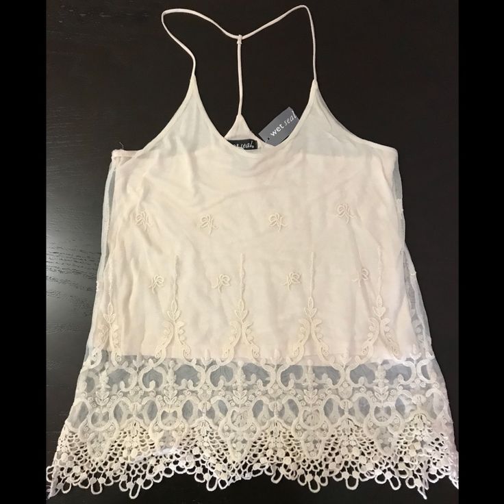 Ivory Double-Layered Camisole. Bottom Layer Is Cotton For Coverage While Top Layer Is Sheer With 3d Design Lace Embroidery. 2 Straps On Shoulders Combine Behind Neck Into 1 Strap For A Racer Back Style. This Versatile Top Can Easily Be Dressed Up Or Down For A Night Out For A Delicate Look Or A Casual Day And Still Look Cute! Brand New With Tag! (Tag Price Torn) Non-Smoking/Pet-Free Home. Sheer Lace Camisole Top, Summer Sheer Camisole Tank Top, Sheer Lace Cami Top, Sheer Cami Tops For Summer, Summer Sheer Spaghetti Strap Tank Top, Sheer Camisole Tops For Summer, Sheer Spaghetti Straps Tank Top For Summer, White Lace Tank Top For Spring, Sheer Spaghetti Strap Tops For Summer