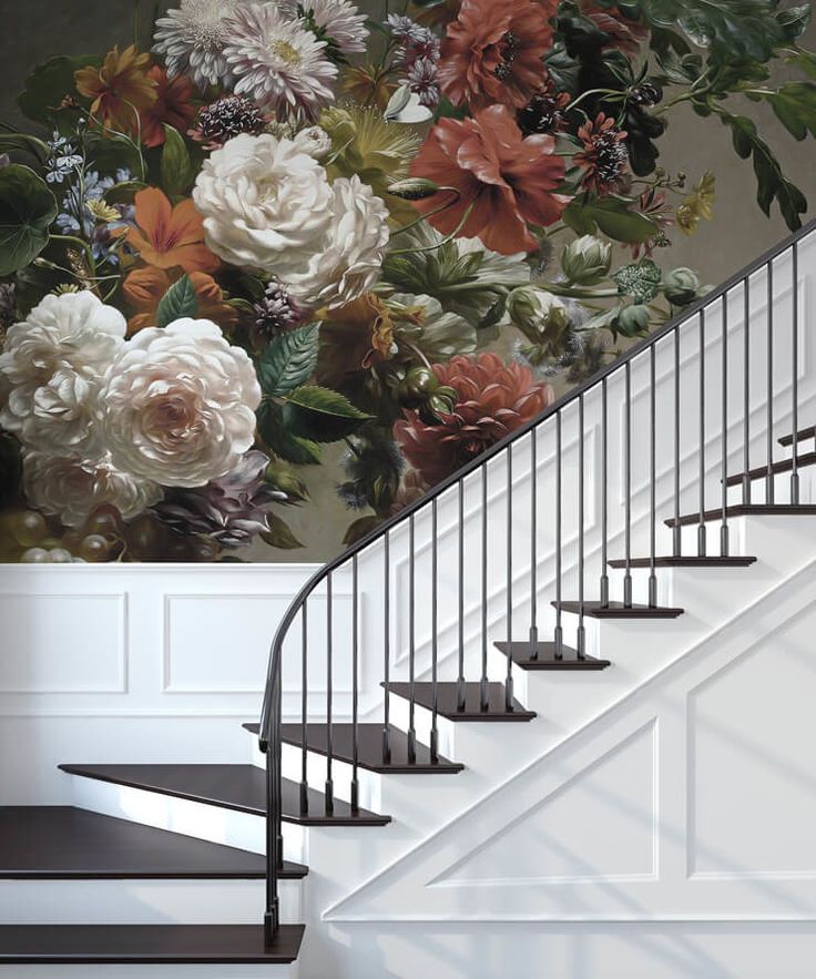 a staircase with flowers painted on the wall