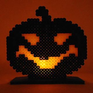 an illuminated pumpkin made out of perler beads