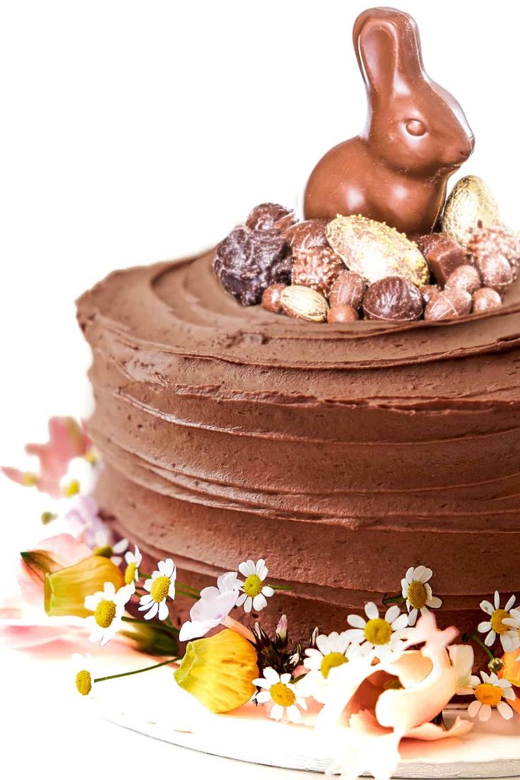 a chocolate cake with flowers and an easter bunny on top