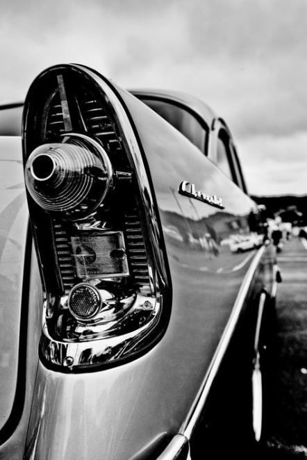 the rear end of a car parked in a parking lot