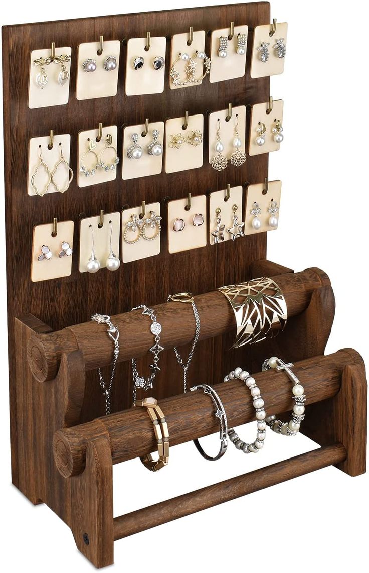 a wooden display with jewelry on it