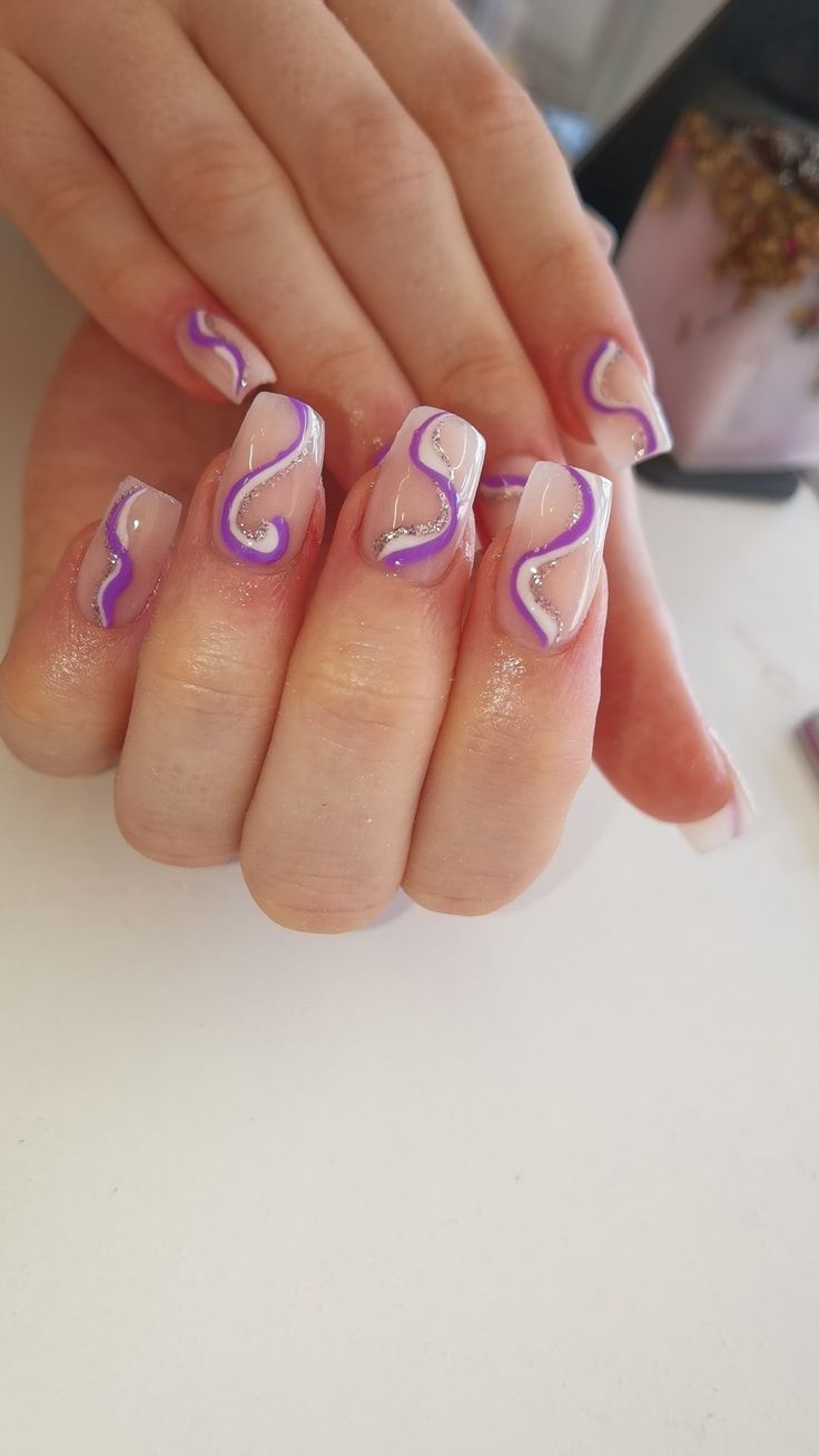 Acrylic nails with purple swirls Purple And Silver Swirl Nails, Lavender Swirl Nails, Swrill Design Nails, Acrylic Nails With Purple, Purple Design Nails, Purple Swirl Nails, Swirly Nail Designs, Nails With Swirls, Silver And Pink Nails