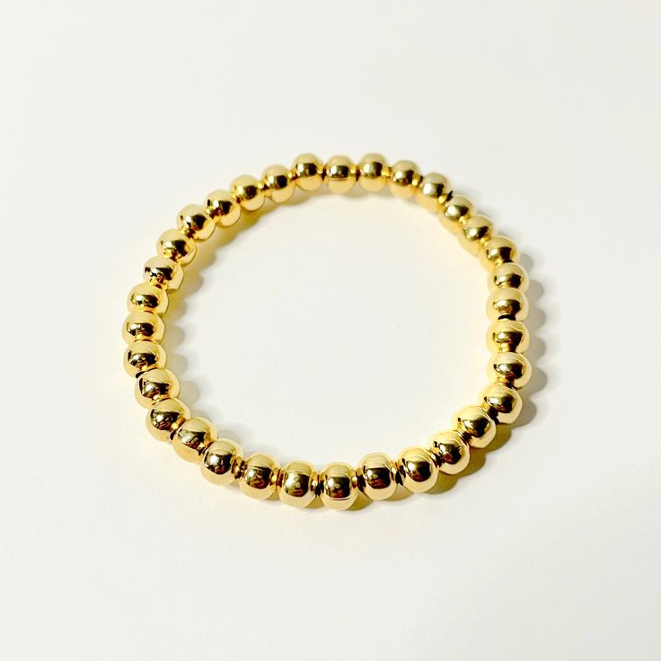 "Pretty Little Essentials - The 24K Gold Bracelet, 5mm 24k gold 5mm beads Recommended Sizing: Measure your wrist, and add 1/2\" Infant (<1 yr): 4.5\" Toddler (1-3 yrs): 5\" Child XS (3-5 yrs): 5.25\" Child S (5-7 yrs): 5.5\" Child M (8-10 yrs): 6\" Child L (10-12 yrs): 6.25\" Adult XS: 6.5\" Adult S: 6.75\" Adult M: 7\" Adult L: 7.25\" Adult XL: 7.5\"" Gold Hypoallergenic Bracelet, Gold Bracelet With 8mm Beads, Stackable Round Gold Bracelet, Gold Bracelet With 8mm Beads For Everyday, Everyday Gold Bracelet With 8mm Beads, Gold Bangle Bracelet With 8mm Beads, Classic Gold Stretch Bangle Bracelet, Classic Gold Bangle Stretch Bracelet, Gold Jubilee Bracelet With Round Beads