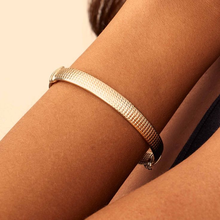 Inspired by the Grand Prix of Monaco, our Moto Bangle exudes style. Featuring a wide, flattened solid gold tube, it is hand etched with a vintage design that offers a classic yet modern look. The Finer Points: Metal: 14 Karat Yellow Gold Dimensions: 8mm Wide Tube, 60mm Diameter Weight: 7.4 Grams Construction: Latch with Figure Eight Closure Origin: Crafted in Arezzo, Italy Timeless Gold Engraved Bangle, Timeless Gold Engraved Bracelets, Timeless Gold Engraved Bracelet, Classic Etched Gold Bracelet, Modern Etched Gold Jewelry, Classic Hammered Yellow Gold Bracelets, Elegant Etched Yellow Gold Cuff Bracelet, Elegant Engraved Thick Band Jewelry, Elegant Engraved Metal Bangle