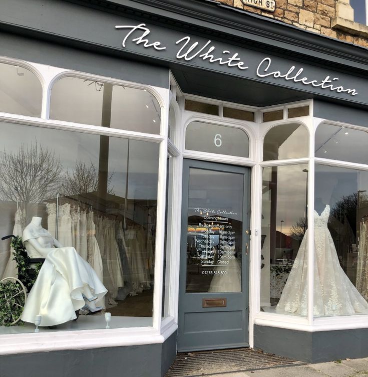 the white collection storefront with wedding gowns on display in it's windows