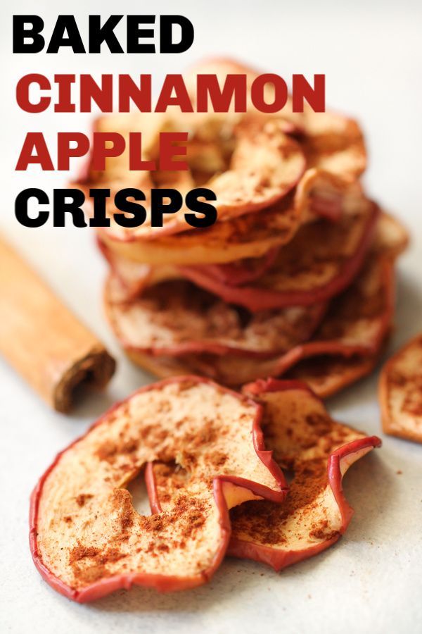 baked cinnamon apple crispes on a white surface with cinnamon sticks and cinnamon stick in the background