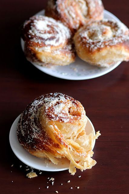 powdered sugar covered donuts on white plates