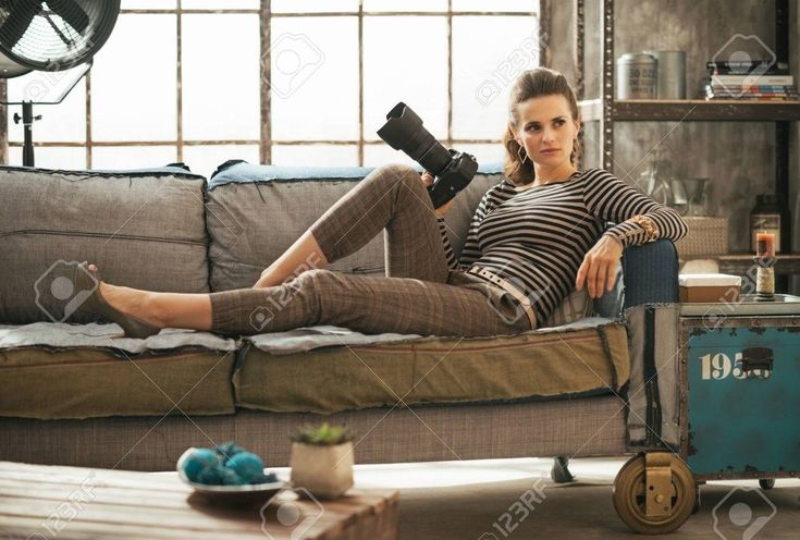 a beautiful woman sitting on top of a couch