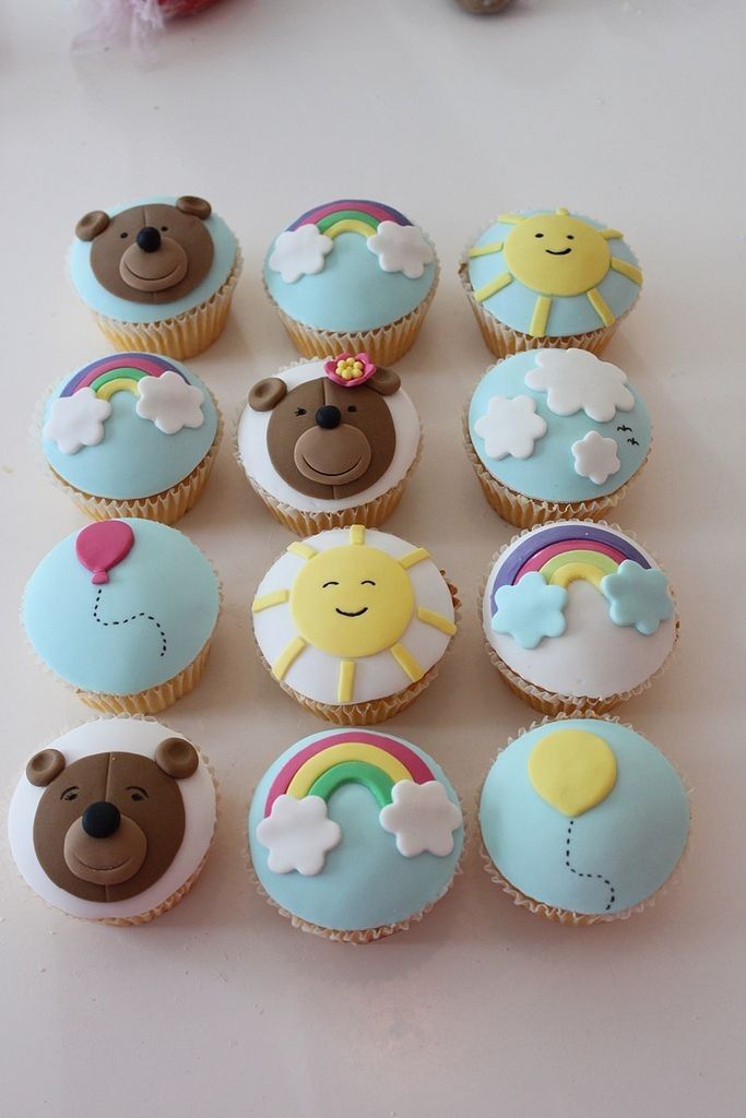 there are many cupcakes that have been decorated with teddy bears and rainbows