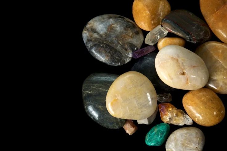 some rocks and stones on a black surface