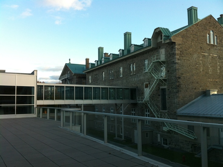 the building has many windows and balconies on it's roof top terrace