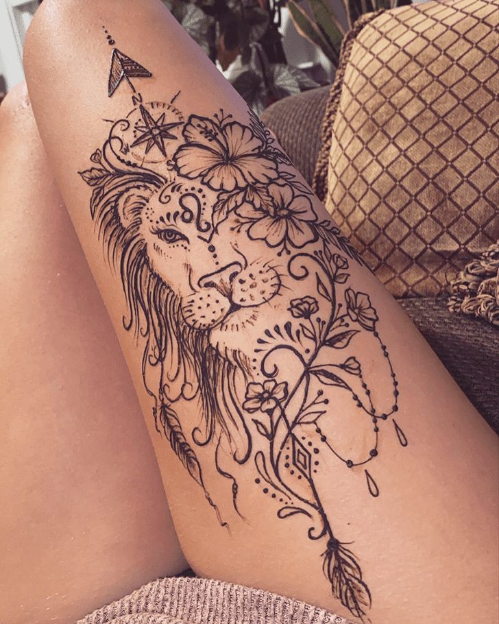 a woman's leg with a tattoo on it that has a lion and stars