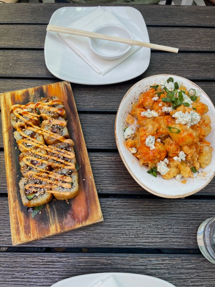 a table topped with plates and bowls filled with food