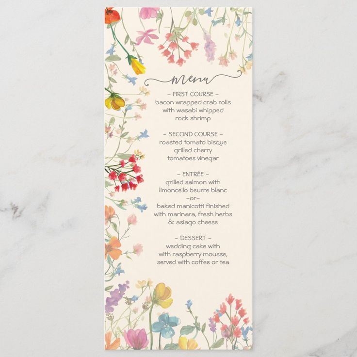 the wedding ceremony program card is decorated with colorful flowers and leaves on white marble background