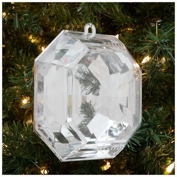 a clear glass ornament hanging from a christmas tree