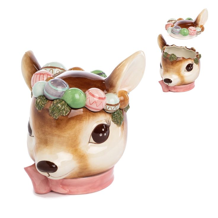 a ceramic deer figurine with buttons on it's head