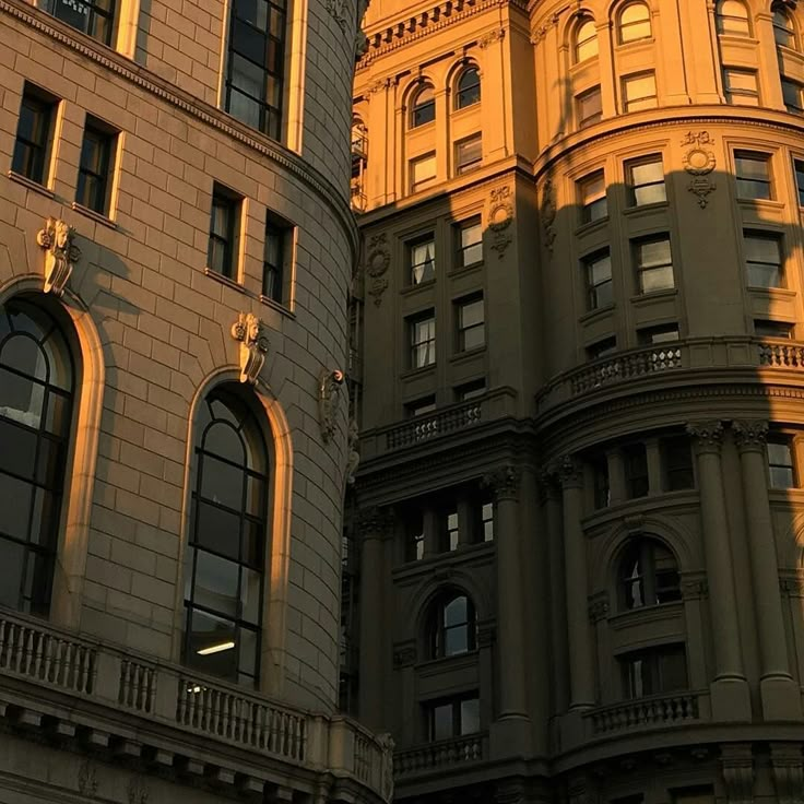 an old building with many windows in the middle of it and a clock at the top