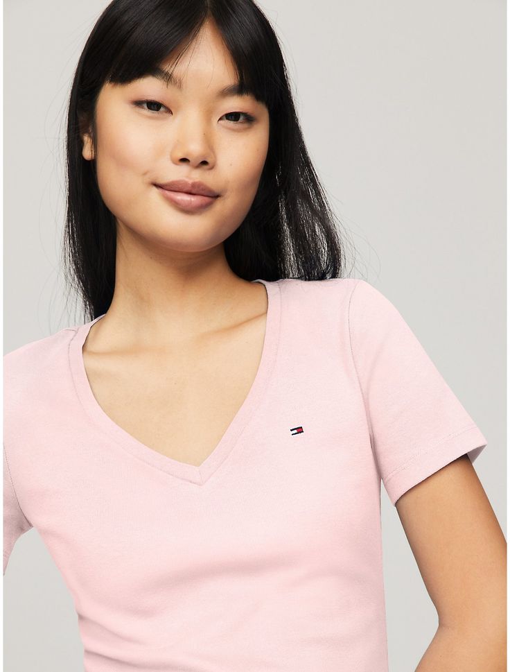 Tommy Hilfiger women's T-shirt. Made from soft, medium weight cotton, our Favorite Tees are designed to fit your form. Another reason to love them? They layer just as easily under a blazer as they do a zip hoodie.  Material: 100% Regenerative Cotton. Trendy Tommy Hilfiger Cotton T-shirt, Classic Tommy Hilfiger T-shirt For Summer, Classic Tommy Hilfiger Summer T-shirt, Classic Pink V-neck Top, Spring Trendy Tommy Hilfiger Tops, Trendy Tommy Hilfiger Tops For Spring, Trendy Tommy Hilfiger Cotton Tops, Trendy Tommy Hilfiger Crew Neck Top, Trendy Tommy Hilfiger Spring Tops