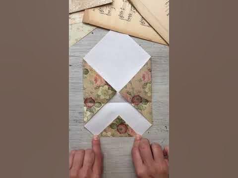 someone is making an origami piece out of paper