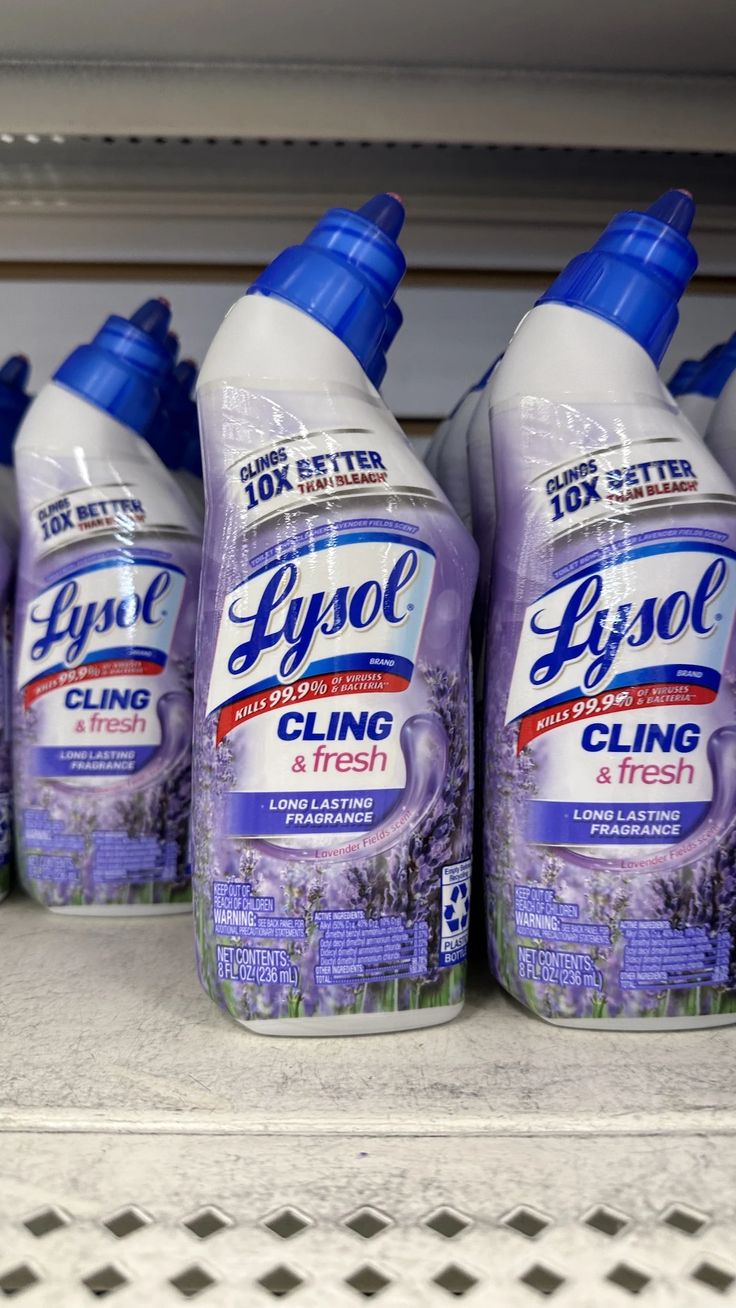 several bottles of lysol cling sitting on a shelf