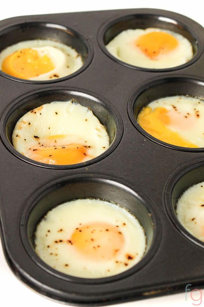 eggs in a muffin pan on a white surface