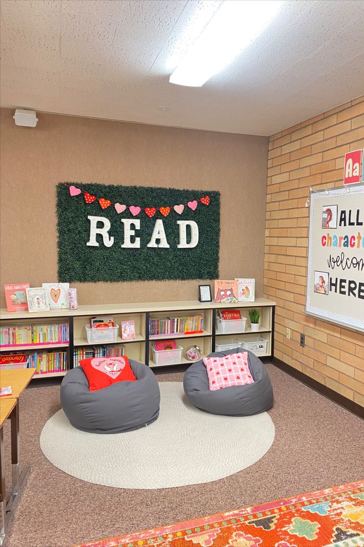 a room with two bean bags on the floor in front of a sign reading read