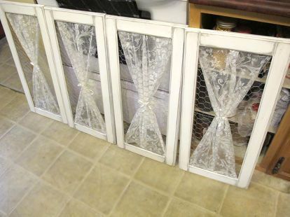 three windows with clear plastic coverings on them in front of a kitchen counter top