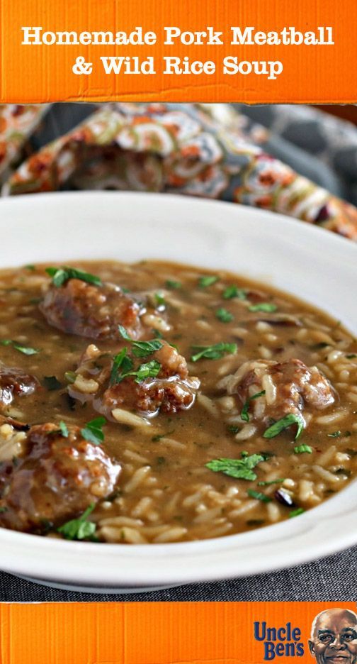 homemade pork meatball and wild rice soup in a white bowl on an orange background