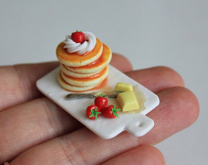 a miniature plate with pancakes and cheese on it