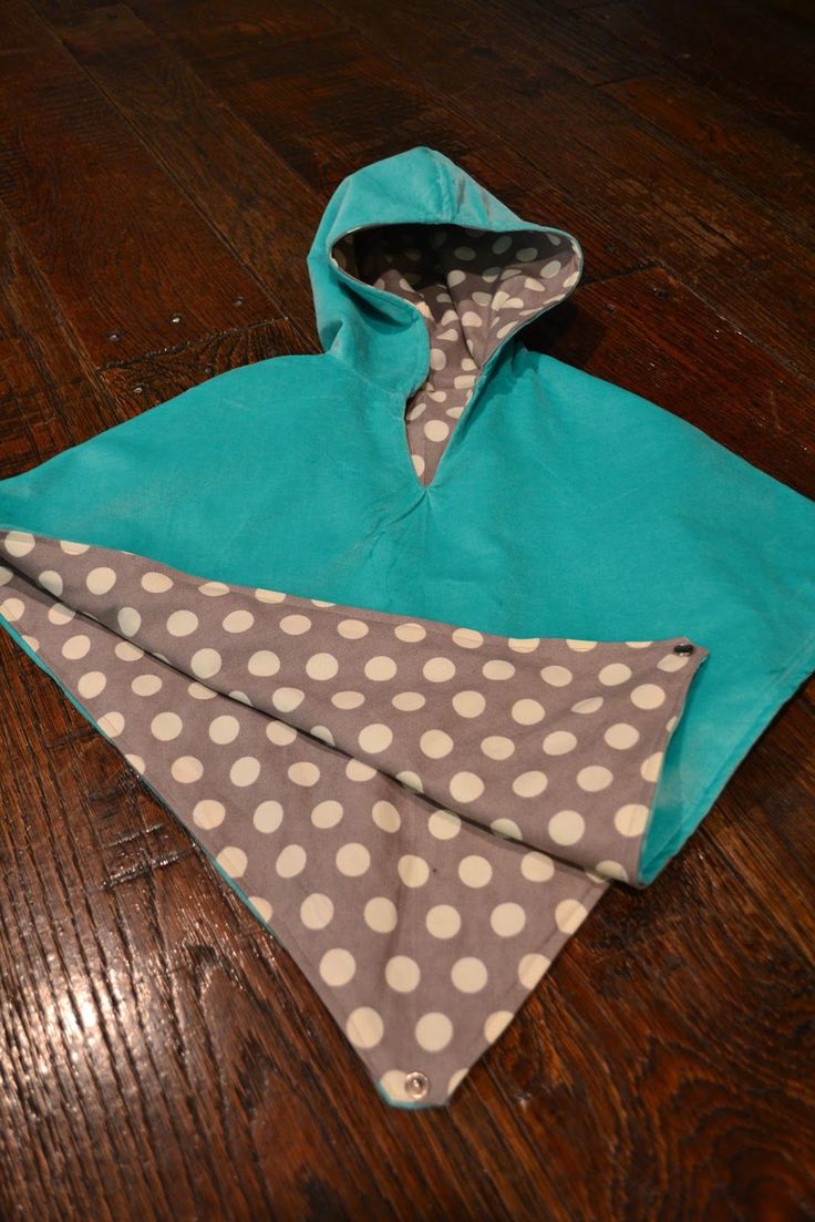 two pieces of cloth are laying on the floor next to each other, one has a hoodie with polka dots