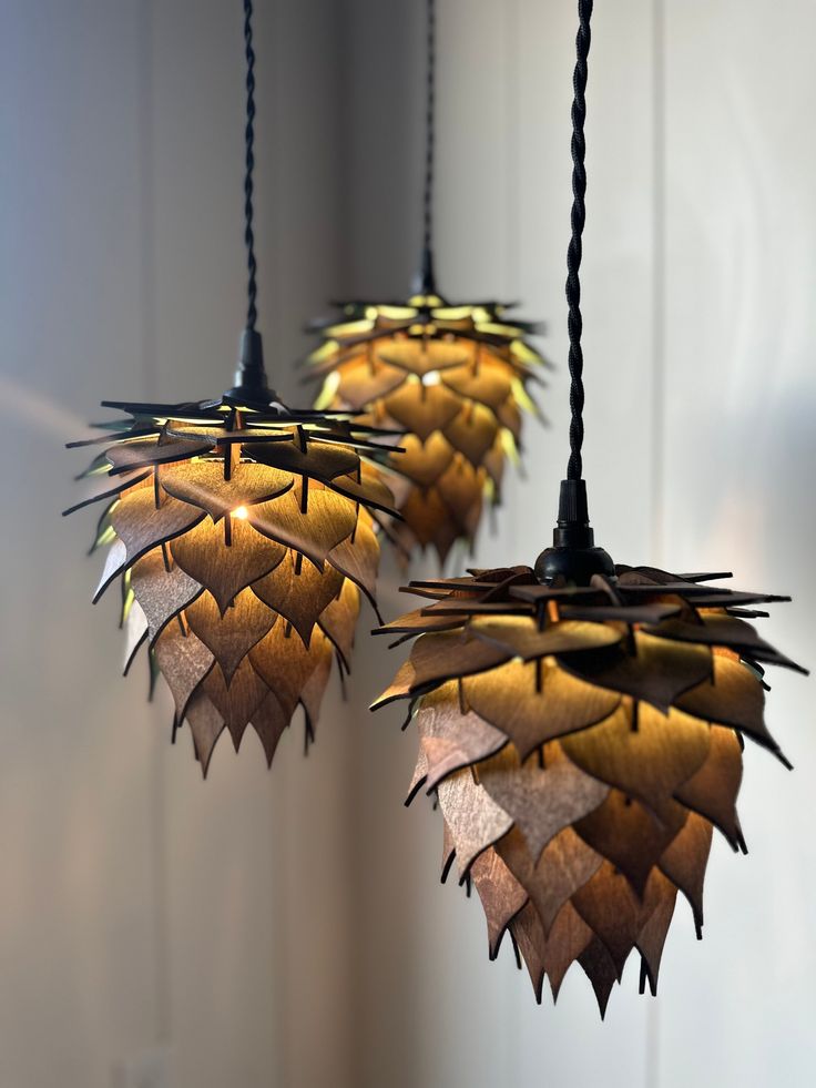 three hanging lights made out of wood sticks