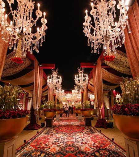 an elaborately decorated area with chandeliers and potted plants