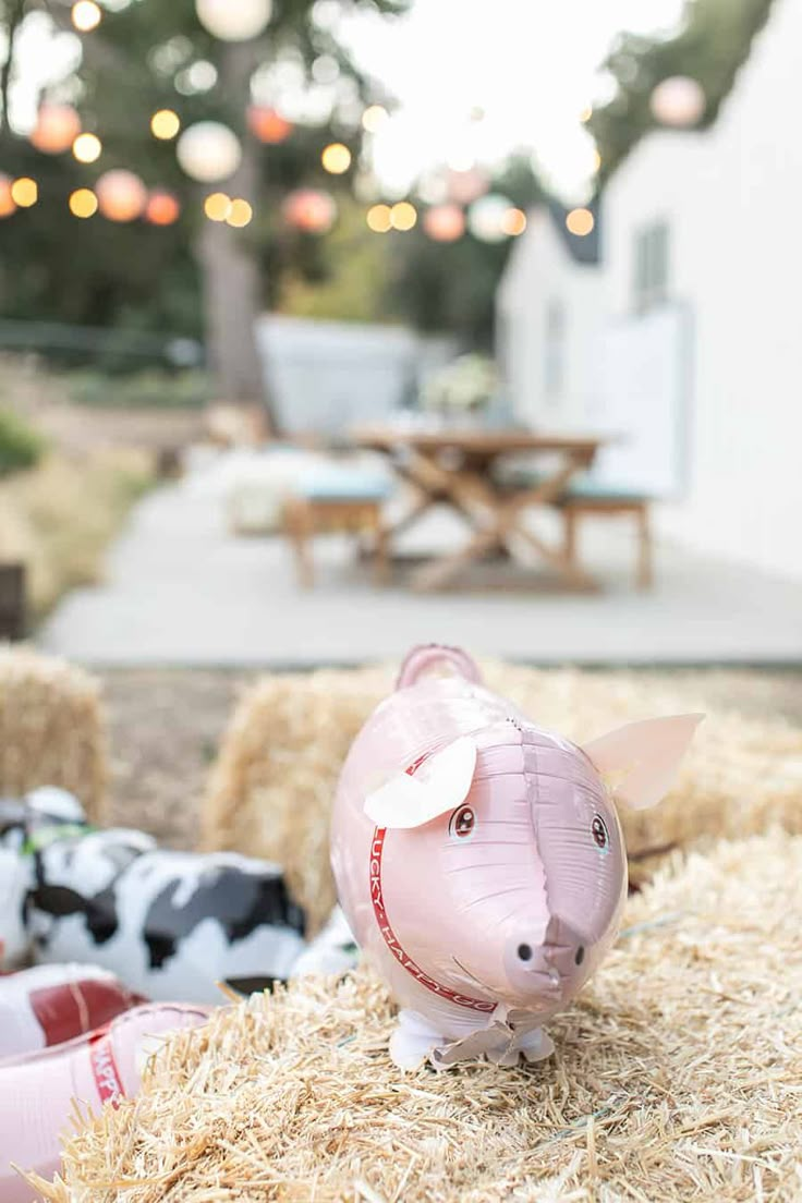 a pig statue sitting on top of hay