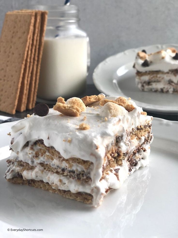 a piece of cake sitting on top of a white plate next to a glass of milk