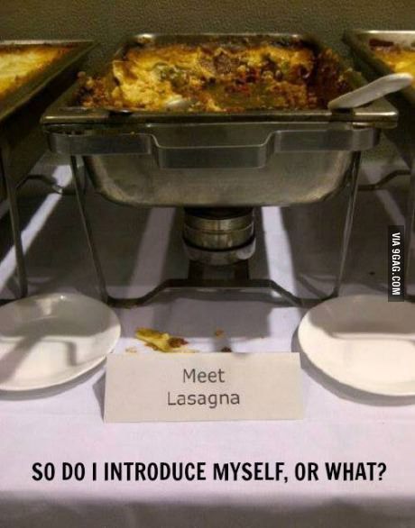 there are many different types of food on the table and one has a sign that says meet lasagna