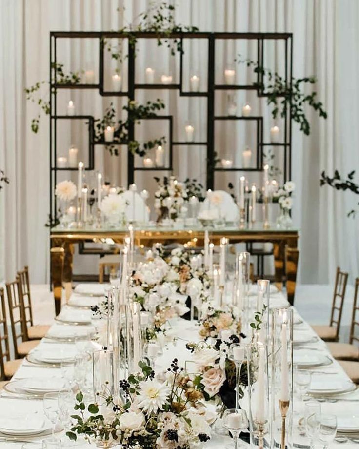 a long table is set with white flowers and candles for an elegant wedding reception at the four seasons resort