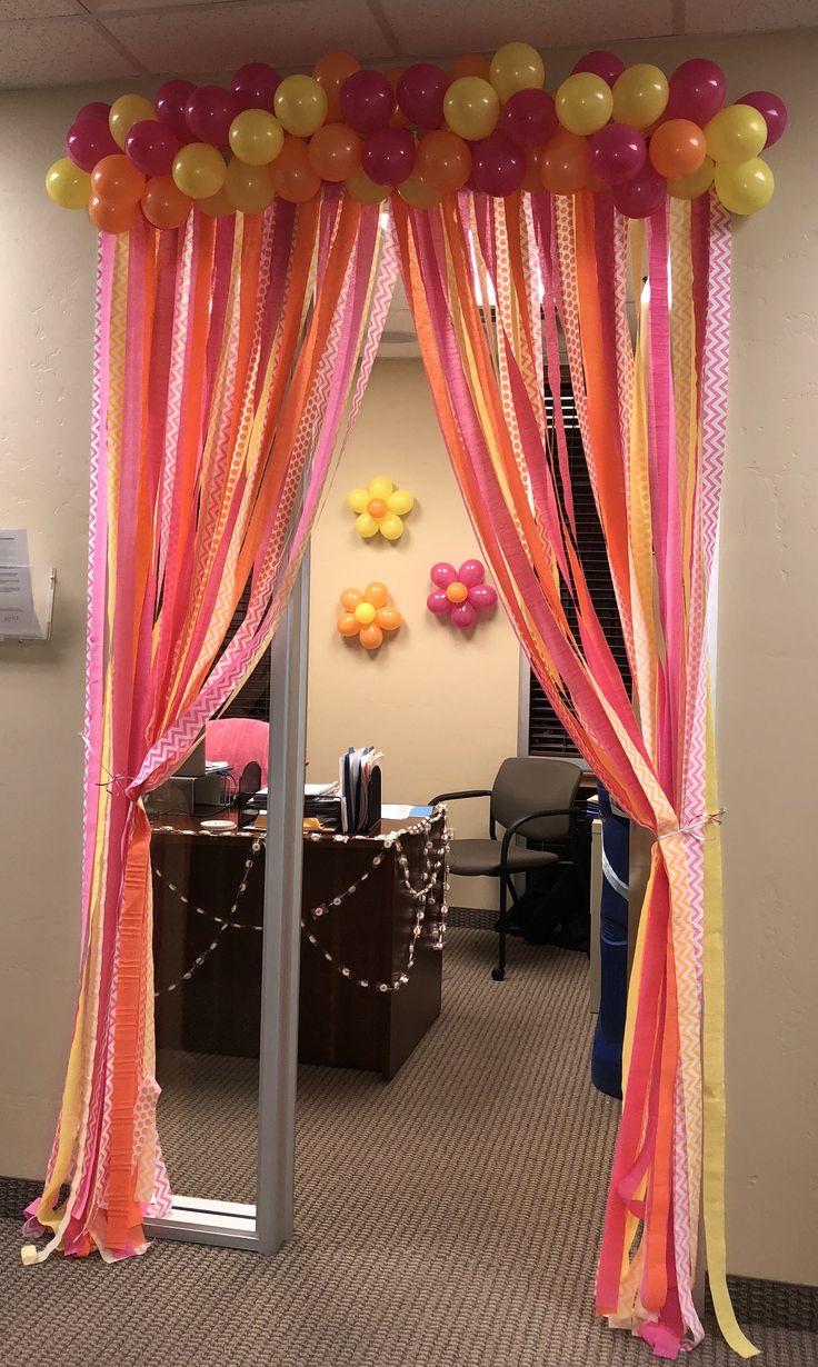 an office decorated with balloons and streamers