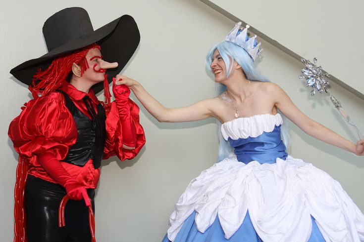 two people dressed in costumes standing next to each other