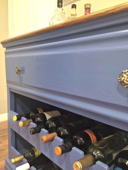 a blue dresser with wine bottles in it