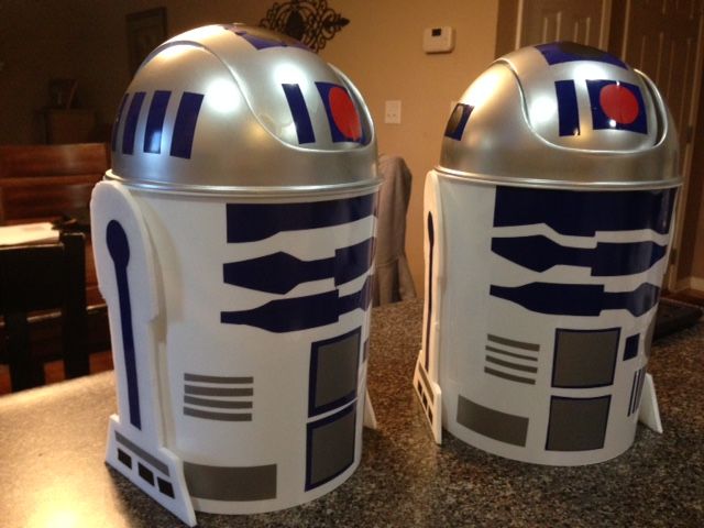 two star wars r2d2 tin canisters sitting on top of a counter