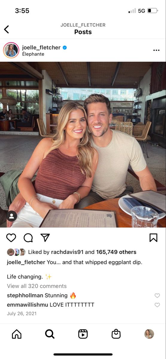 a man and woman sitting at a table with food in front of them on instagram