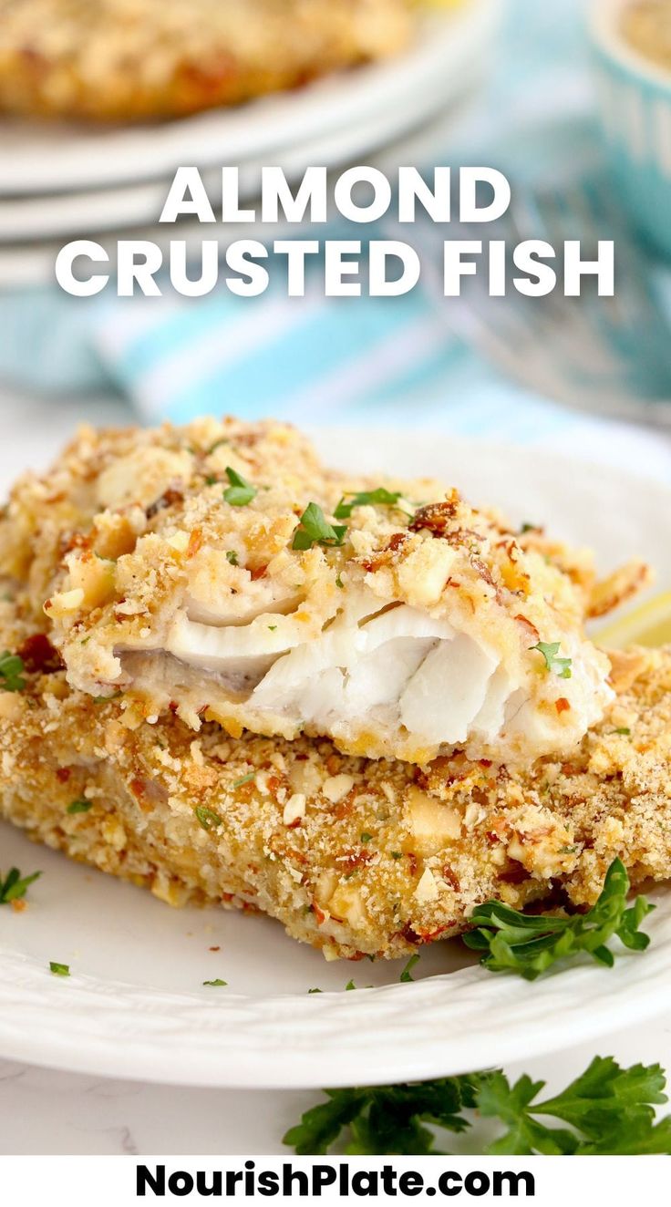 a close up of food on a plate with the words almond crusted fish above it