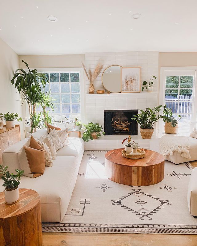 a living room filled with furniture and plants