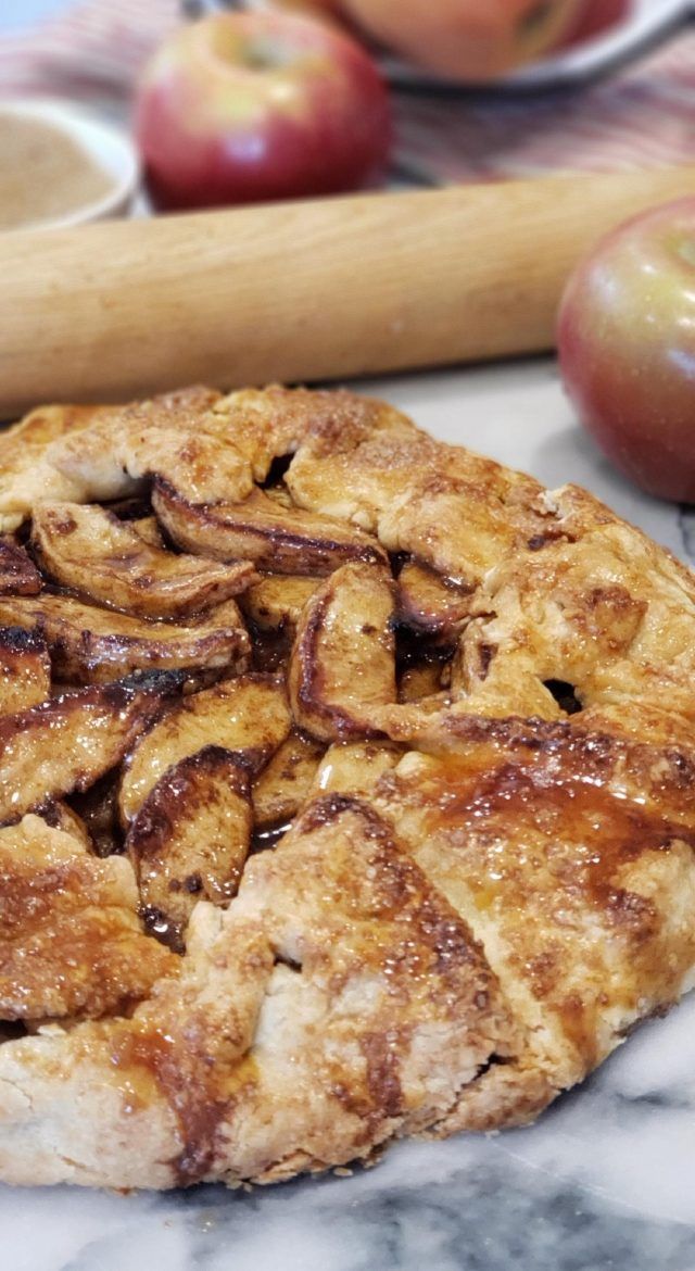 an apple pie sitting on top of a marble counter