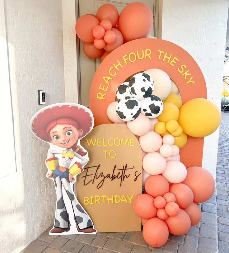 a welcome sign with balloons and decorations on the front door to a birthday party for a young boy