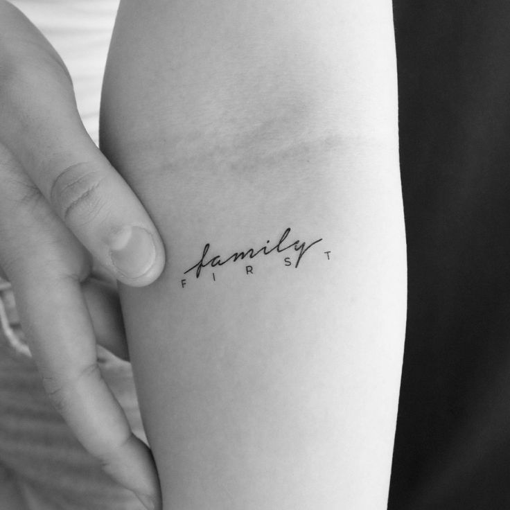 a woman's arm with the word family on it and her name tattooed in cursive font