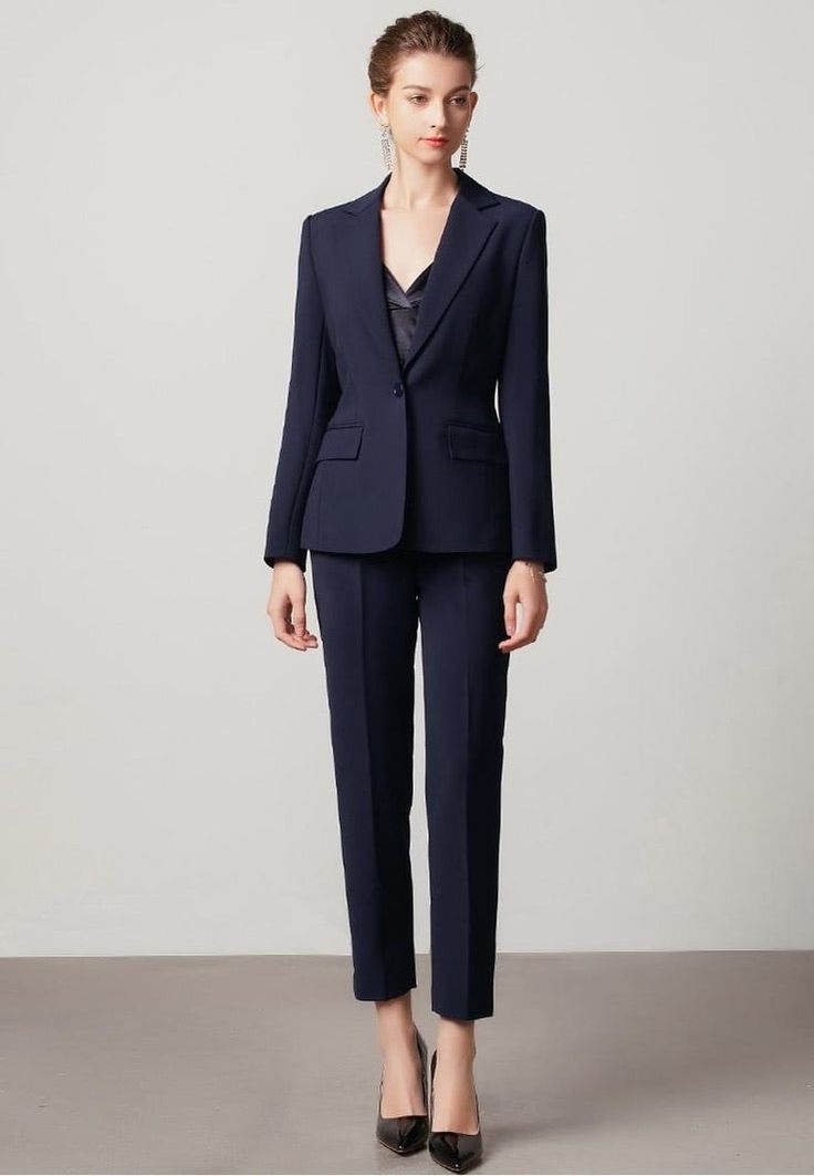 Elevate your style with this timeless navy blue v-neck pantsuit. Crafted with a flattering cuff sleeve, this sophisticated outfit will keep you looking chic while providing everlasting comfort. Feel confident and ready for any occasion! Description: Peak lapels; front button blazer V-Neck, Long sleeves; Structured shoulders. Single button Straight leg Hip flap pockets Polyester 69% Viscose 29% Spandex 2% Imported Brand - Aision Model Number - 211031C1+P1 Sleek Notched Suits For Workwear, Chic Notched Suit For Career, Navy Suits For Office Wear With Collar, Sleek Notched Suits For Office Wear, Sleek Notched Suit For Office Wear, Sleek Notched Suits For Office, Elegant Navy Blazer For Work, Elegant Pantsuit With Welt Pockets For Office Wear, Elegant Business Casual Pantsuit With Pressed Crease