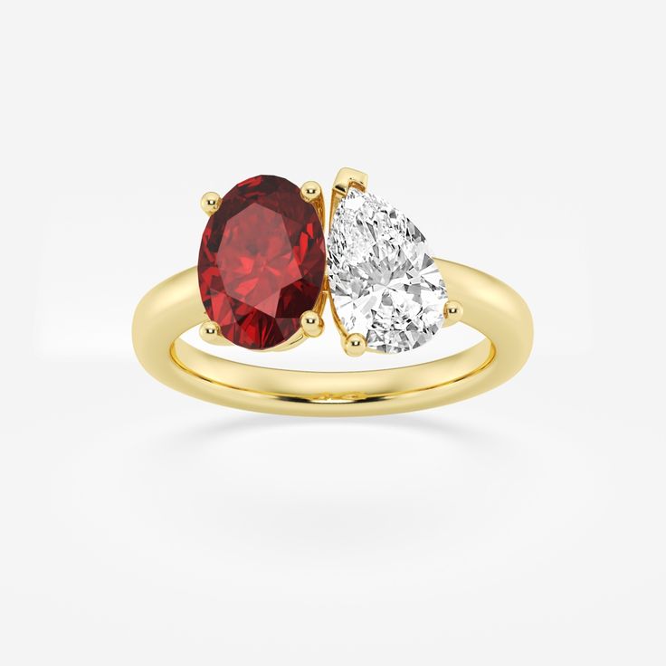 two stone engagement ring in yellow gold with red and white diamonds on the sides, set against a plain background